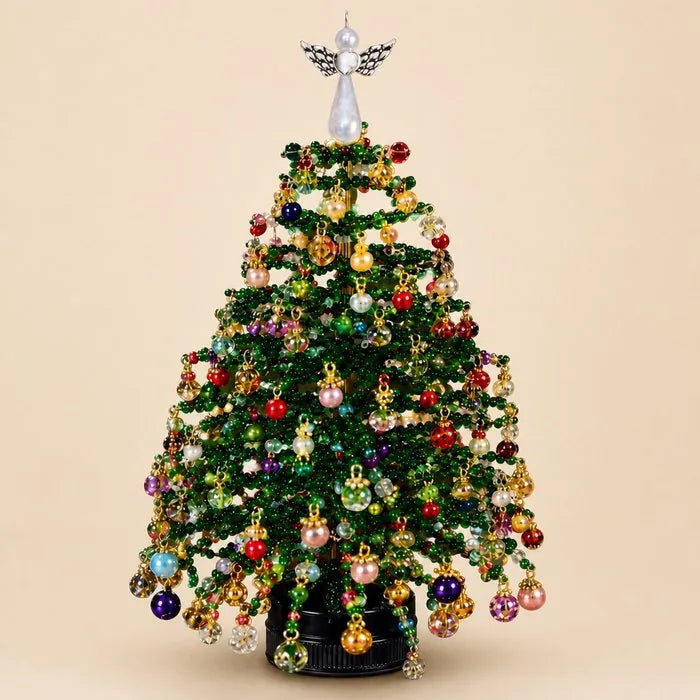 Beaded Christmas tree kit finished tree with pearl angel topper on a beige studio background
