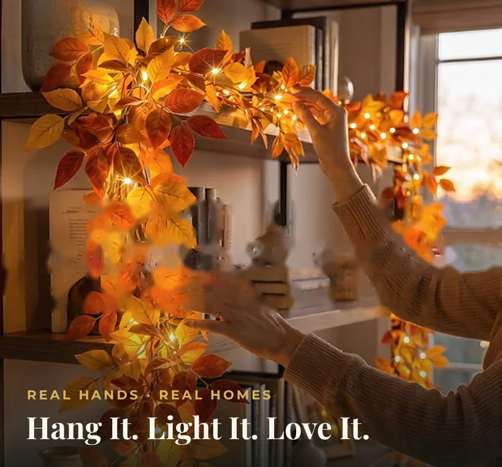 Hands draping the light-up autumn leaf garland along a bookshelf — hang it in minutes, no tools needed